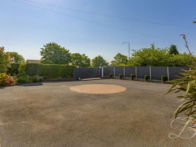 Our last photo shows how a carriage driveway at the front of the house offers lots of space for off-street parking. Accessed by electric gates, it also leads to an attached garage.