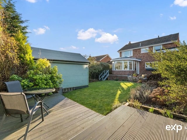The paved patio creates a large seating area with steps that lead down to the lawn. This gorgeous spot offers plenty of space for garden seating and enjoys the perfect vantage point across the garden for relaxing in the warmer months and enjoying al fresco dining.