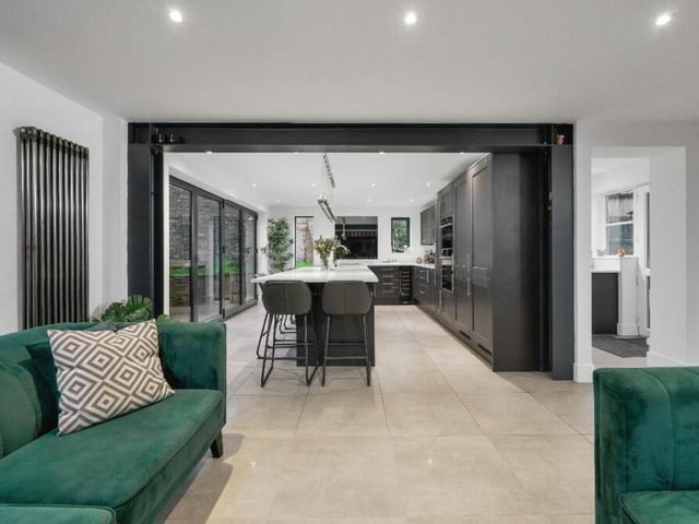 This shot of the living/'dining area shows how feature exposed steels provide a gateway to the kitchen.