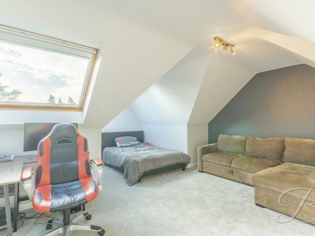 A further set of stairs takes us to the second floor and the remaining two bedrooms. This stylish one is a fine size, with two Velux windows, a carpeted floor and access to an en suite room.