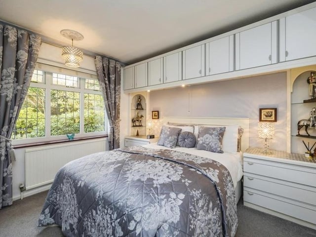 It's time to inspect the three bedrooms now, beginning with this, the biggest, which faces the front of the bungalow. It boasts fitted furniture and also a carpeted floor.