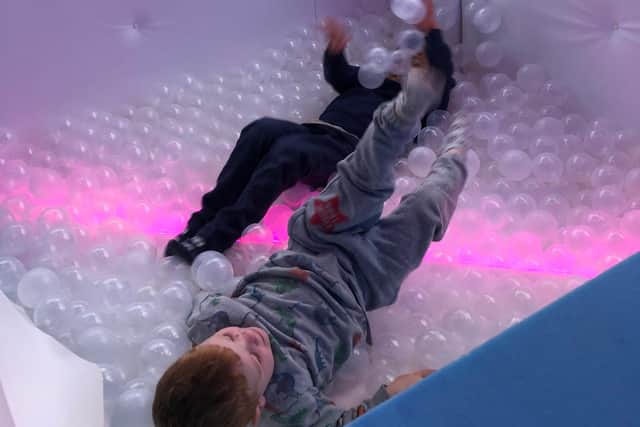 Children having fun in the ball pit.