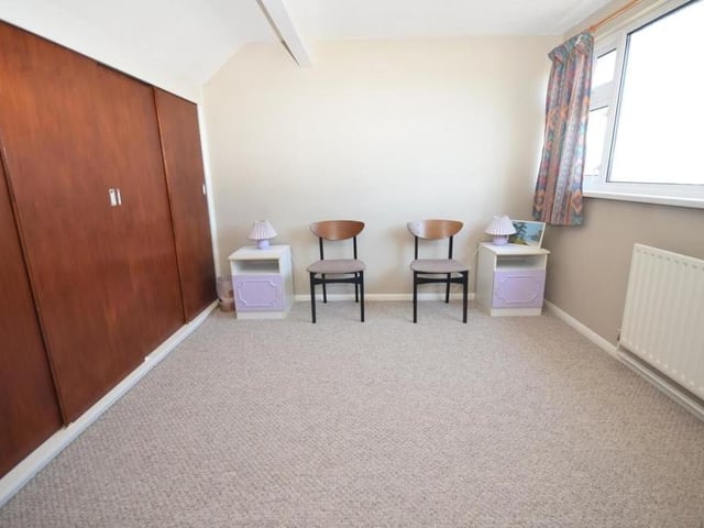 It's up to the first floor now, and this is one of the other two bedrooms at the £300,000-plus property. A sizeable space, its main feature is a large and useful, built-in wardrobe. The final bedroom also boasts a built-in wardrobe.