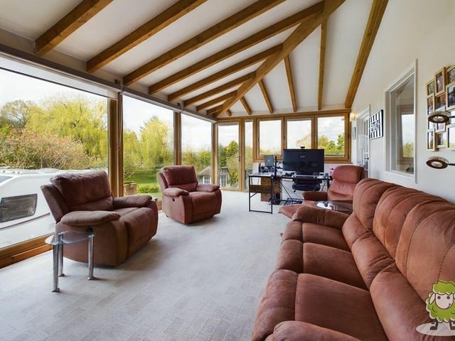 An extension to the living room is this sun room, which is a fantastic area in which to chill out or work from home. It offers terrific views.