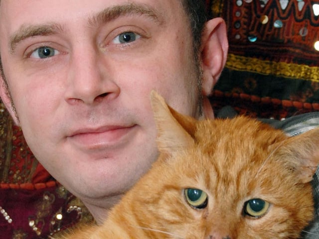 Phil McGuire with cat Indie in 2011.
