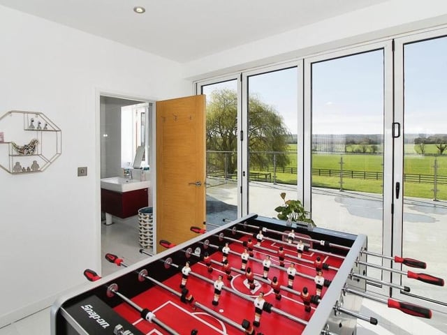 A close-up of the bi-folding doors that lead out to the balcony and the access to en suite facilities in the main bedroom/living room on the first floor.