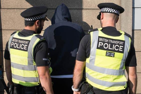 Police officers stop and search someone.