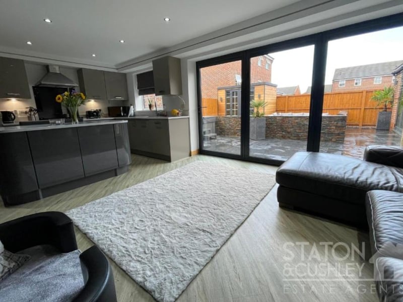 The open-plan kitchen/diner/living area has large bi-folding doors that bring in plenty of natural light and also open out to the rear garden.