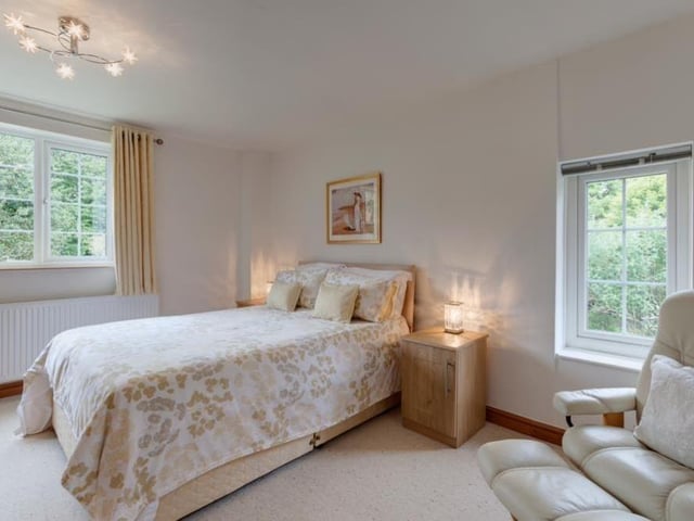 Bedroom number two is another spacious double with en suite facilities, courtesy of a Jack and Jill family shower room. A range of fitted furniture includes shelves and drawers.