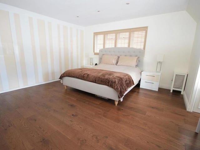 The main bedroom includes this bank of custom-fitted wardrobes, giving functional storage space.