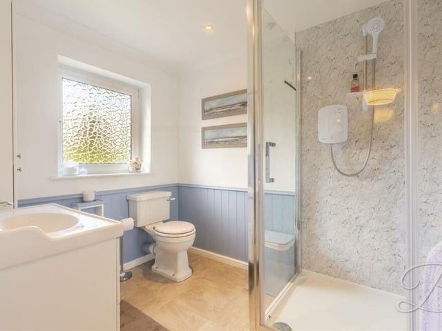 Here is the en suite to the master bedroom. It consists of a walk-in shower cubicle, low-flush WC, vanity wash hand basin and downlights.