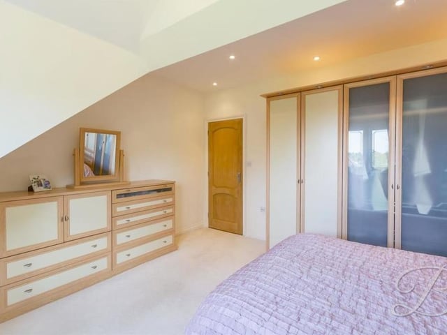 Although the fourth bedroom does not possess en suite facilities, it does feature these fitted wardrobes and lots of storage space.