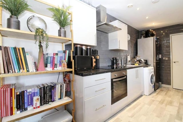 The kitchen at the £80,000-plus apartment boasts a variety of appliances. such as an integrated cooker and hobs, inset sink and drainer, and also washing machine.