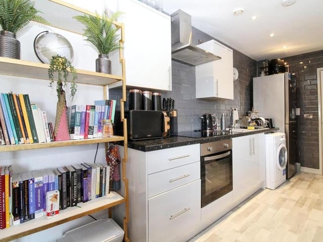 The kitchen at the £80,000-plus apartment boasts a variety of appliances. such as an integrated cooker and hobs, inset sink and drainer, and also washing machine.