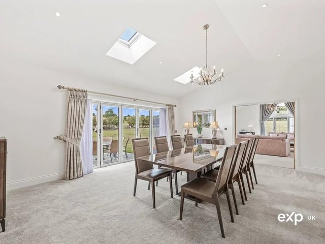 This multi-purpose reception room is ideal as a dining room, being located between the kitchen and the lounge. There is ample room here for a big dining table and chairs. Bathed in light, the vaulted ceiling has two Velux windows, along with ambient down lighting adding to the atmosphere. Garden views beckon through bi-folding doors that lead outside onto the patio.