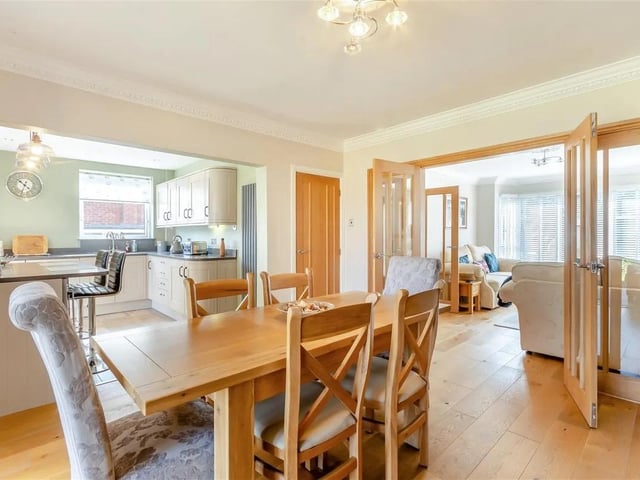 The start of a superb, open plan, dining/kitchen and snug living space. The dining room has oak flooring, two contemporary vertical radiators and coving to ceiling. Open plan to the snug and kitchen.