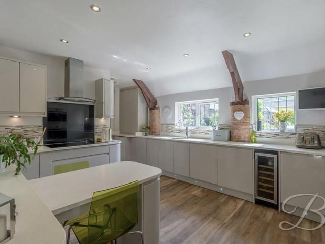 The stunning and spacious kitchen comes with a range of modern gloss units and cabinets, with complementary work surfaces and an inset double sink. A built-in breakfast bar is a nice touch, and a handy utility room, with integrated washing machine, is not far away.