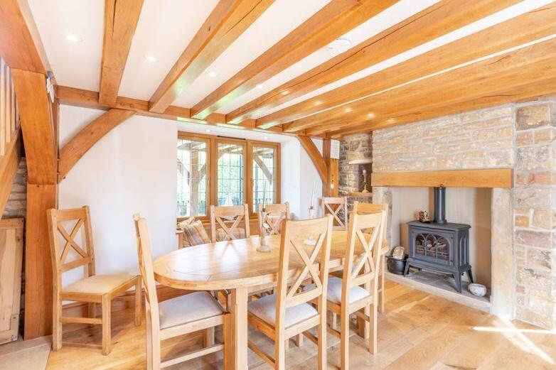 This informal dining room has lots of charm and character, especially with its feature fireplace and stone wall.