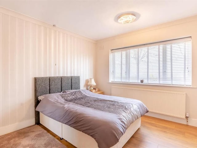 A spacious second double bedroom, with radiator, laminate floor, coving to ceiling and double glazed window to the rear elevation.