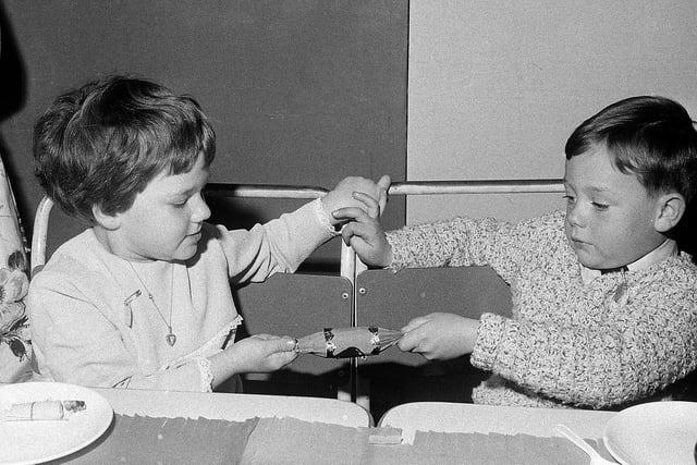 Cracker-pulling time at the Christmas party in 1967.