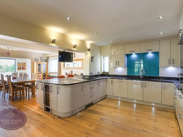 The spacious and well appointed kitchen has a comprehensive range of integrated appliances.