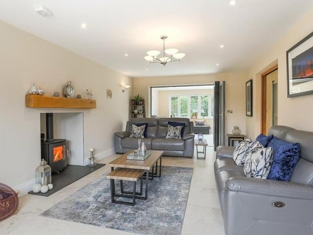 The lounge features an Inglenook fireplace with oak beam and multi-fuel burner.