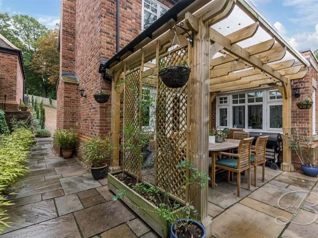 One of two pergola covered patio seating areas
