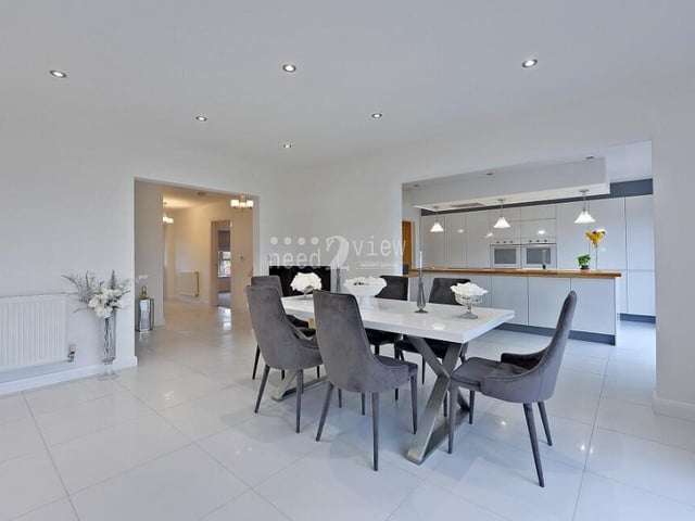 Flowing seamlessly from the kitchen is this dining area which, with its ceiling spotlights, has a sleek appearance to it.