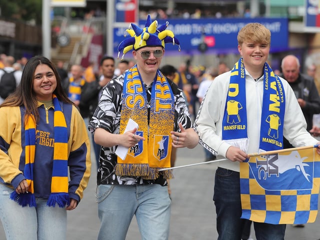 Mansfield Town fans watch the drama unfold inside Wembley.