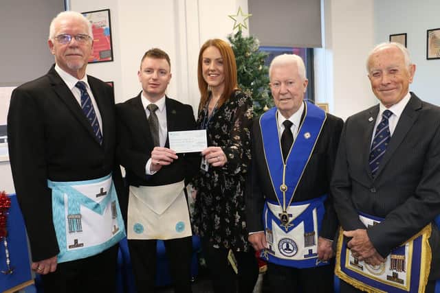 Welfare manager Becky Moore with Freemasons Stephen Gee, Chris Clay, Jim Adams and Andy Campin.