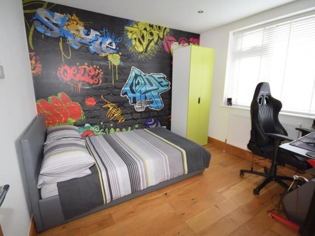 Another of the four double bedrooms. It has solid oak flooring, downlighting, a radiator and a window facing the back of the house.