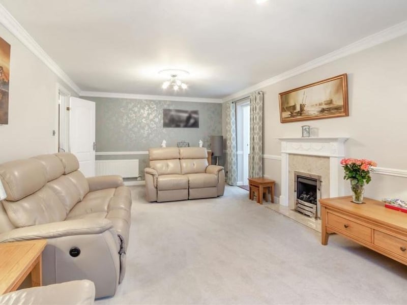 The last shot of the lounge, which also has two decorative ceiling roses, two radiators, a dado rail and coving to the ceiling.