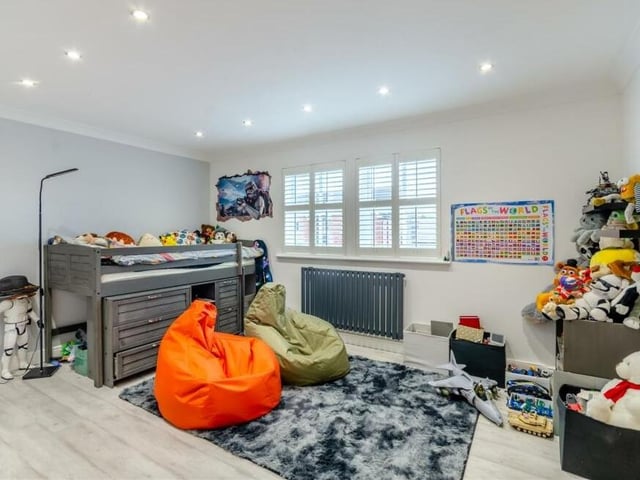 This double bedroom has been fitted out by the current owners to suit a young child. Again, it is extremely spacious and comes with fitted wardrobes and a light grey laminate floor. It overlooks the back of the house.