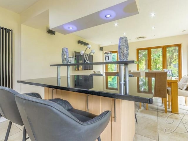 The kitchen/diner includes a central island with breakfast bar and, as you can see in the background, patio doors lead out to the back garden.