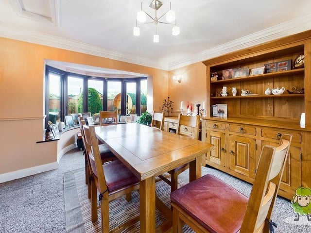Next stop is the delightful dining room, with its feature bay window overlooking the back of the house.