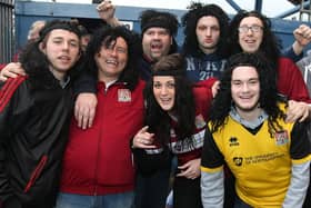 Northampton Town fans wear long hair wigs and headbands in homage to JJ on their 'John-Joe O'Toole Day' away at Mansfield Town.