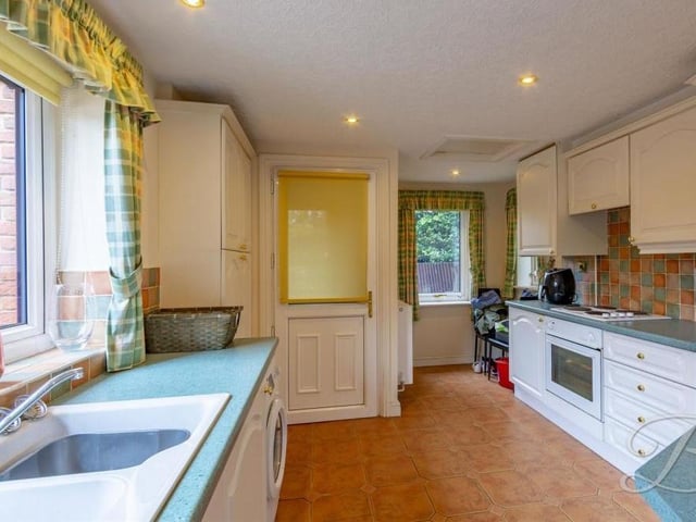 Let's move on now to the annexe, which includes this traditional kitchen. It boasts an integrated oven, hob and extractor fan, and space and plumbing for a washing machine.