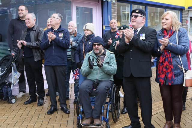 Armed forces veterans, proudly displaying their medals, show their support at the opening of Spectre Coffee in Sutton town centre.