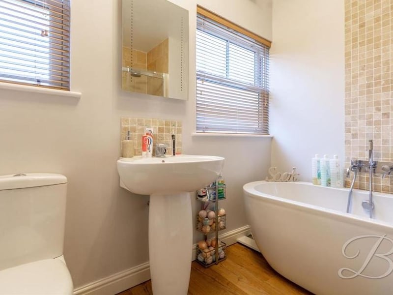 A smart family bathroom comprises a four-piece suite that includes a free-standing bath, low-flush WC and hand wash basin.