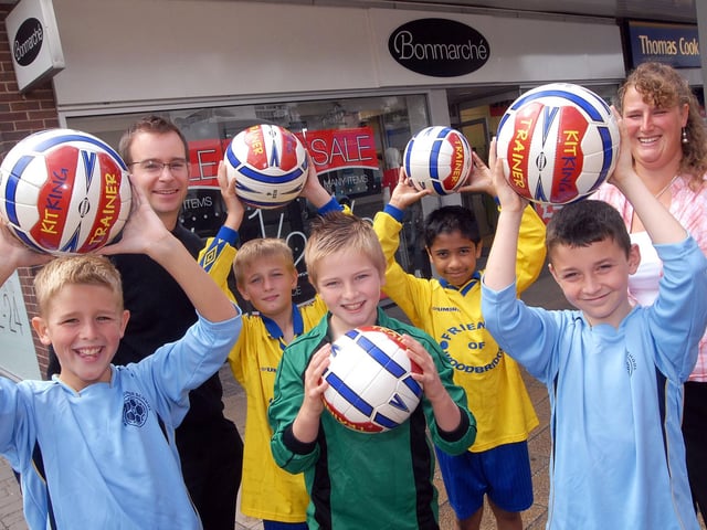 Woodbridge Junior School's  football team members try on their new kit thanks to Alfreton Clothing Store Bon Marche. Pictured from left, are , Luke Day, teacher Mr Paul Wilde, Jack Massey, James Stevenson, Matthew Aniyan, Joshua Marriott and sales assistant Rebecca Day.