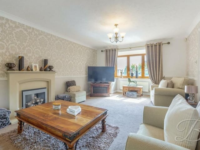 Moving on now to the impressive lounge or living room, which includes a cosy feature fireplace and a bay window that allows a wealth of natural light to fill the space perfectly.