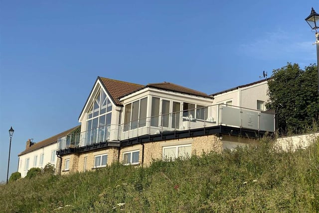 The property features beach access, two spacious terraces with an interconnecting walkway as well as on-site parking and a remote-controlled garage.