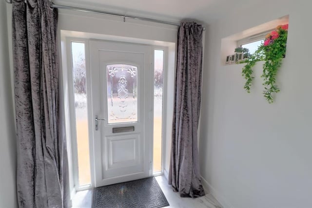 The uPVC double-glazed front door welcomes you into the house, via a light and airy entrance hallway that has a tiled, marble-effect floor with underfloor heating.