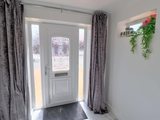 The uPVC double-glazed front door welcomes you into the house, via a light and airy entrance hallway that has a tiled, marble-effect floor with underfloor heating.