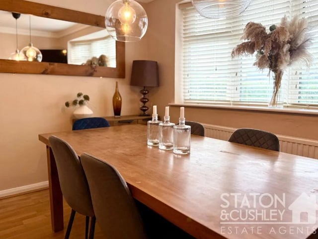 The generous family dining room offers ample space for both formal dining and a cosy seating area.