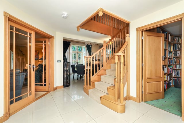 This is the reception hallway, where doors open into the library, music room and sitting room. "The oak staircase that leads up to the first floor provides a glimpse of the quality and craftsmanship on offer throughout the property," the estate agent says.