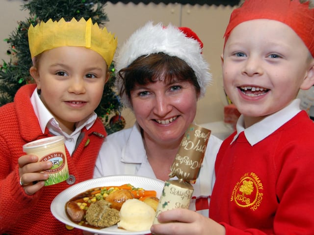 Pupils at Kirkby's Morven Park Primary School enjoyed a free Christmas dinner back in 2007. Pictured is Kitchen Assistant Jackie Smith with Keisha Bonser and Ethan March.