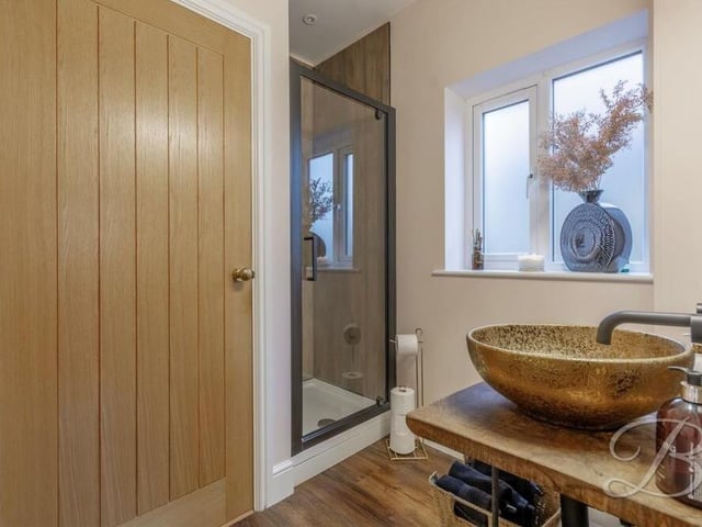 The en suite to the downstairs bedroom includes a contemporary, walk-in shower cubicle.