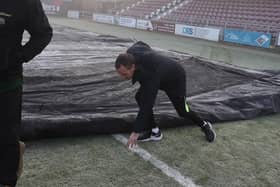 Referee Geoff Eltringham tests the pitch during an inspection as the game is called off prior to the Sky Bet League Two between Northampton Town and Mansfield Town at Sixfields. (Photo by Pete Norton/Getty Images)