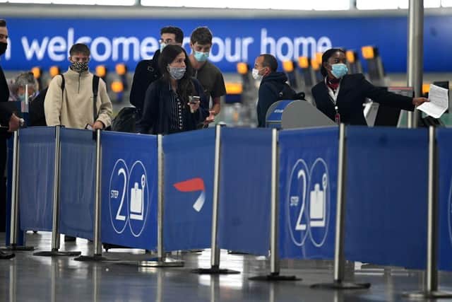 Passengers wearing face masks or covering due to the COVID-19 pandemic. (Photo by DANIEL LEAL-OLIVAS / AFP) (Photo by DANIEL LEAL-OLIVAS/AFP via Getty Images)